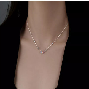 Silver necklace with bezel-set zircon cluster pendant and delicate charms