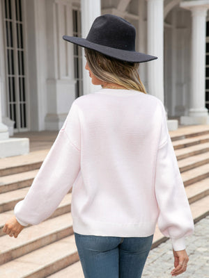 White acrylic knit sweater with balloon sleeves and a subtle heart motif.