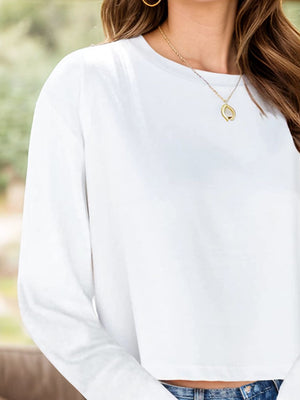 White cropped crewneck long sleeve top with a relaxed fit.
