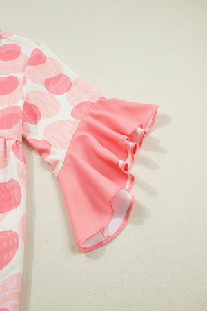 Polka dot babydoll blouse with pink ruffle trim sleeves.