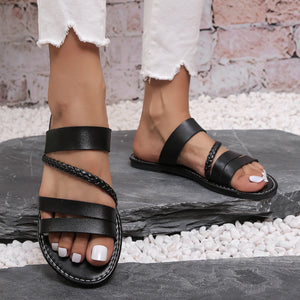 Black braided strap open-toe flat sandals with multiple leather straps.