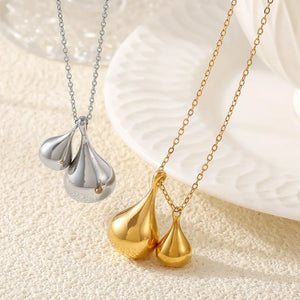 Gold and silver necklaces with polished teardrop pendants, a chic duo.