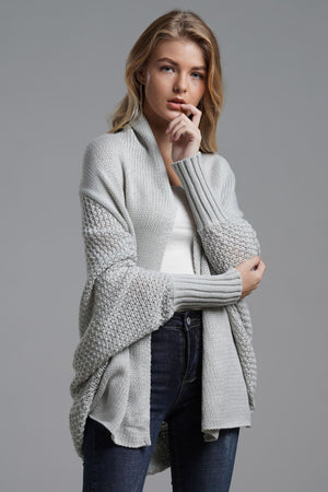 Gray batwing knit cardigan with drape front and textured sleeves.