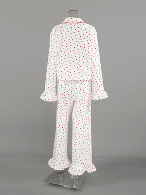 White cotton pajama set with red hearts, ruffled cuffs, and collar trim.