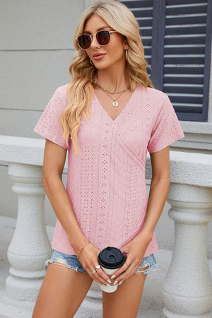 Blush pink eyelet wrap v-neck top with short sleeves and a textured pattern.