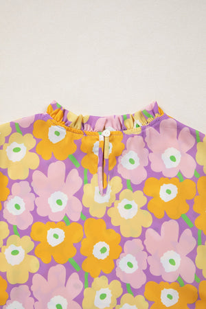 Puff sleeve blouse with ruffle trim and floral print, featuring a buttoned keyhole neckline.