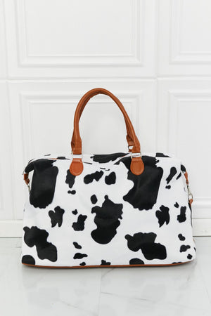 Cowhide print duffel bag with brown leather handles