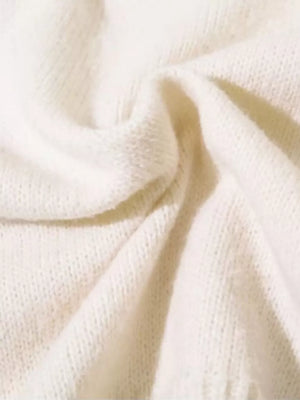 Cream knit sweater with textured details and abstract pattern.