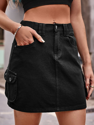 Black denim utility mini skirt with cargo pockets and elastic waistband.
