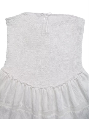 White smocked strapless mini dress with eyelet hem and bow detail