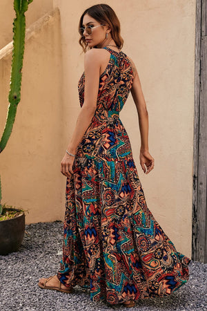 Halter neckline maxi dress with a vibrant paisley print in brown, green, and blue tones.