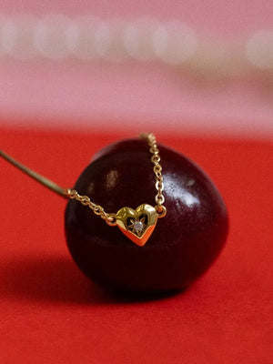 Gold heart pendant necklace with diamond accent on delicate chain