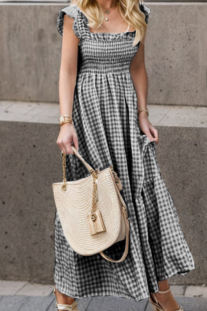 Smocked gingham maxi dress with flutter sleeves and square neckline.