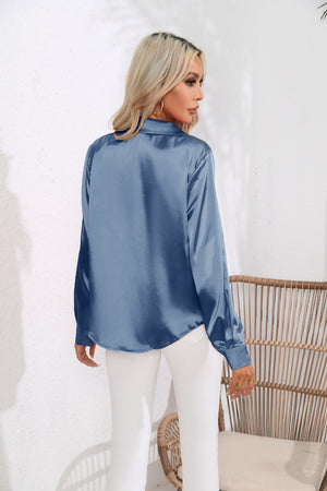 Glossy satin button-down blouse in light blue, shown from the back.