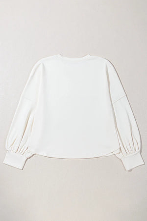 White relaxed fit sweatshirt with gathered balloon sleeves and ribbed cuffs.