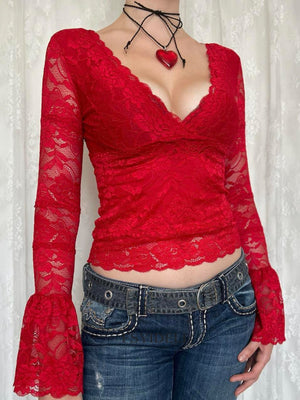 Red lace surplice blouse with scalloped trim and bell sleeves.