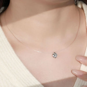 Silver floating moissanite necklace with a clear illusion chain, showcasing a single sparkling 1 ct D color grade pendant.