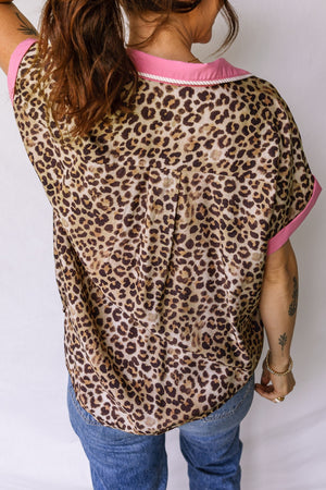Print short sleeve shirt with animal print, pink collar and cuffs, button up style.