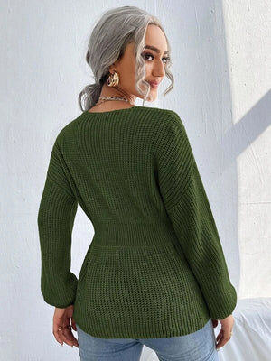 Green peplum knit sweater with scallop neckline and long sleeves.