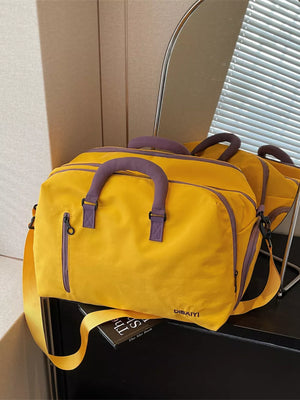 Yellow travel organizer bag with purple accents and adjustable strap
