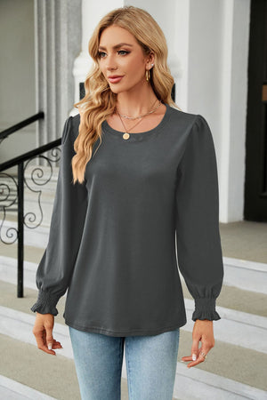Dark gray casual blouse with puff sleeves and smocked cuffs.
