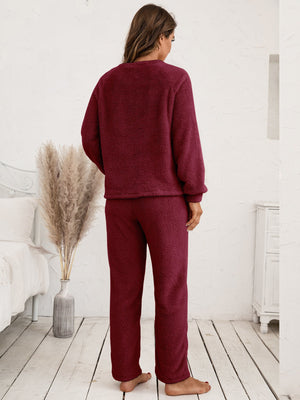 Plush loungewear set in burgundy with raglan sleeves and relaxed fit pants.