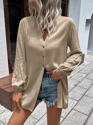 Oversized khaki blouse with mandarin collar, button front, and balloon sleeves.