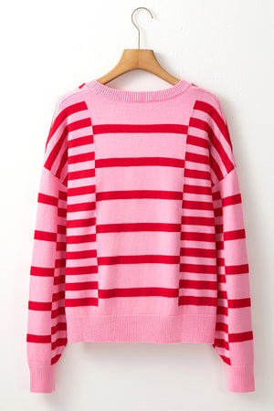 Colorblock stripe knit sweater with balloon sleeves in hot pink and red.