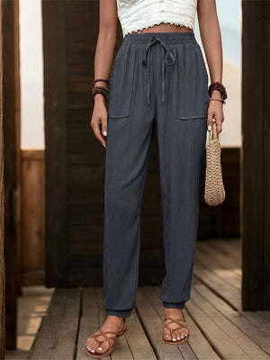Dark Gray textured drawstring waist relaxed trousers with cuffed ankles and patch pockets.