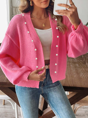 Fuchsia pink bubble sleeve cardigan with pearl buttons and V-neck.