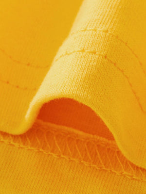 Yellow cotton toddler tee detail showing stitching and fabric texture.