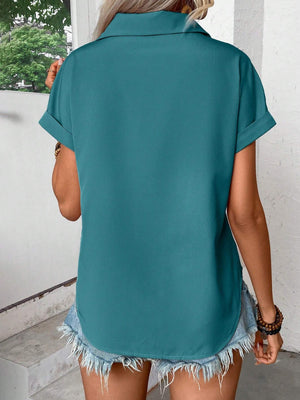 Teal polyester button-down shirt with cuffed short sleeves and a curved hem.