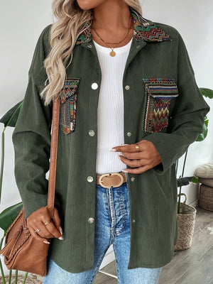 Army green corduroy overshirt with embroidered statement pockets and collar detail.