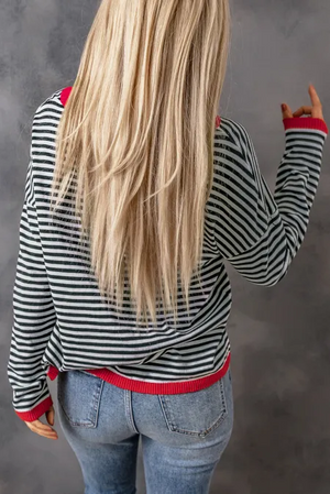 Nautical knit crewneck sweater with black and white stripes and red contrast trim.