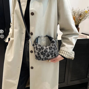 Shearling check mini shoulder bag in gray with silver hardware and black trim.