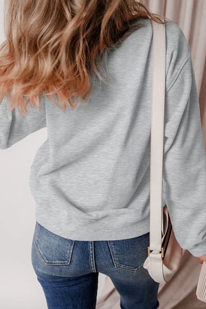 Gray crewneck sweatshirt with cartoon ghost graphic, casual autumn style.