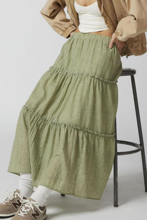 Tiered cotton maxi skirt in matcha green with ruffled tiers and an elastic waist.