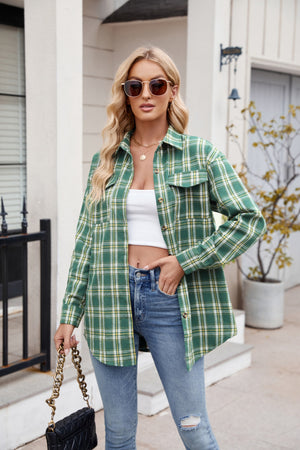 Green plaid overshirt with patch pockets and buttoned front, worn open over a white crop top.
