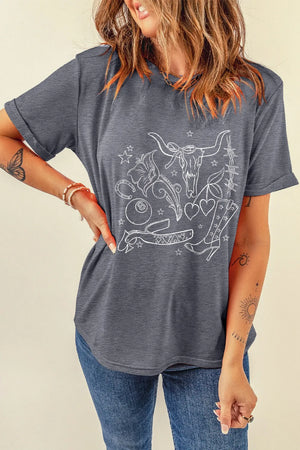 Gray graphic t-shirt with western tattoo print, featuring a bull skull, boots, and hearts.