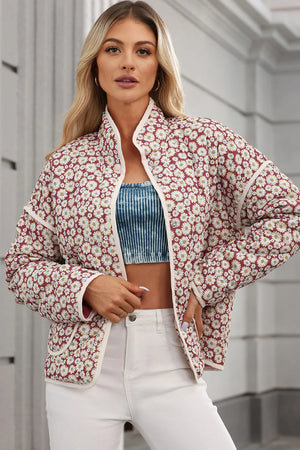Burgundy quilted jacket with daisy print, stand collar, and cream trim.