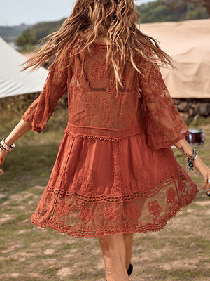 Bohemian rust lace tiered mini dress with bell sleeves and intricate floral embroidery.