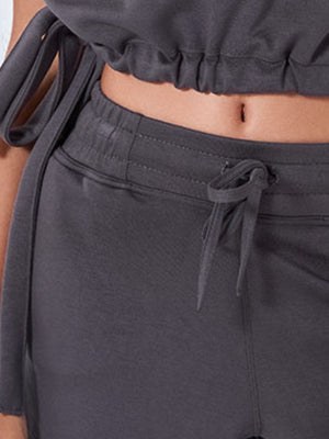 Dark gray drawstring shorts with elastic waistband and tie detail.