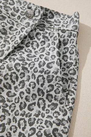 Denim shorts with a grey leopard print pattern and a button closure.