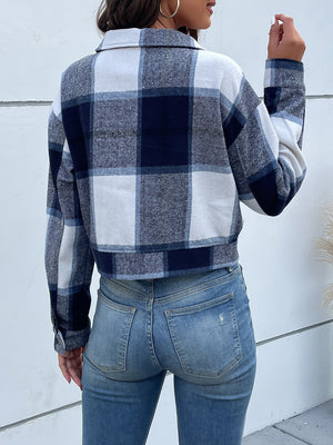 Checked plaid shacket in blue and white with buttoned cuffs and collar.