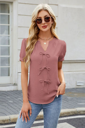 Dusty pink textured blouse with tie-front detail and V-neck