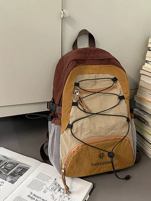 Earthy toned lightweight nylon hiking backpack with bungee detail and mesh pockets.