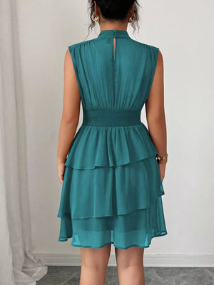 Sleeveless ruffle tiered dress in lake green with smocked waist and button back detail.