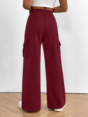 Burgundy high waist cargo sweatpants with drawstring and side pockets.