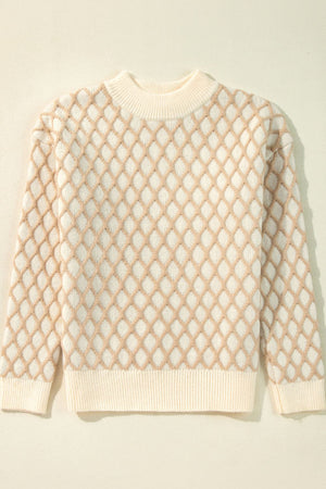 Cream diamond knit sweater with crew neck and ribbed cuffs and hem.