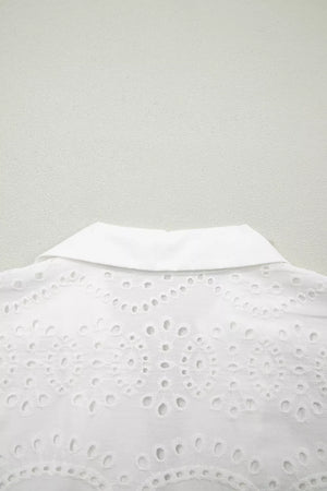 White cotton mini dress with eyelet embroidery and collar detail.